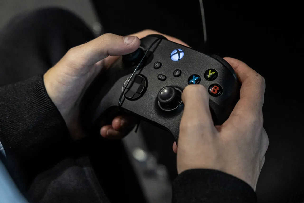 MILAN, ITALY - NOVEMBER 24: A man uses a Xbox gamepad during Milan Games Week 2023 at Rho Fieramilano on November 24, 2023 in Milan, Italy. Milan Games Week is the most important video games festival in Italy, featuring the latest news of gaming industry, the most exciting esports tournaments and amazing digital entertainment moments. (Photo by Emanuele Cremaschi/Getty Images)