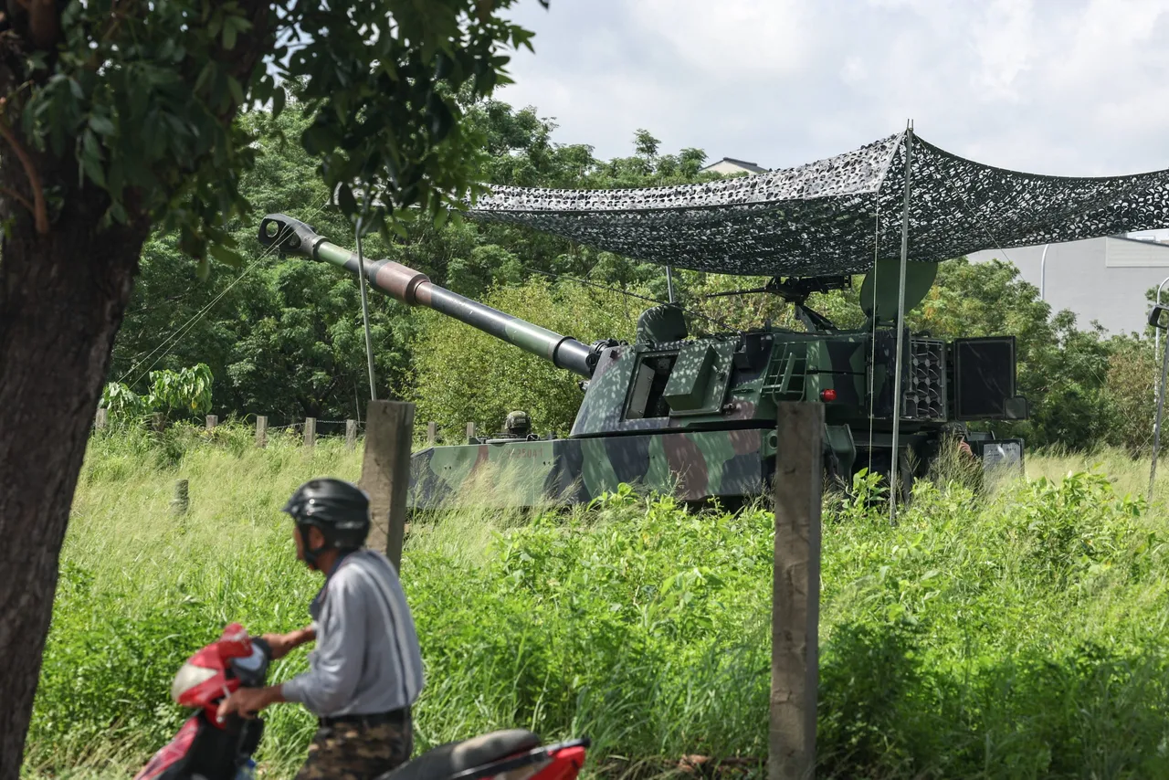 The Taiwanese military conducts a drill simulating an enemy landing using M109A2 howitzers, part of the annual Han Kuang exercises, in Tainan on July 14, 2025. (Photo by I-HWA CHENG/AFP via Getty Images)