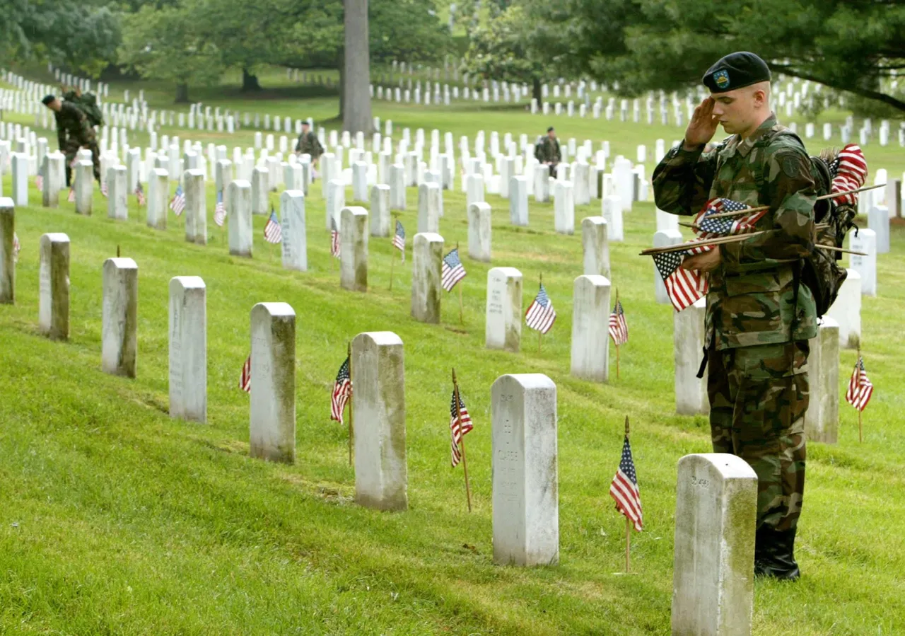 ARLINGTON, VA - MAY 27: A member of the U.S. Army Infantry Regiment (The Old Guard), salutes after placing a flag on a grave stone at Arlington National Cemetary May 27, 2004 in Arlington, Virginia. An event called "Flags In" takes place before every Memorial Day weekend in honor of those veterans who have lost their lives. (Photo by Mark Wilson/Getty Images)