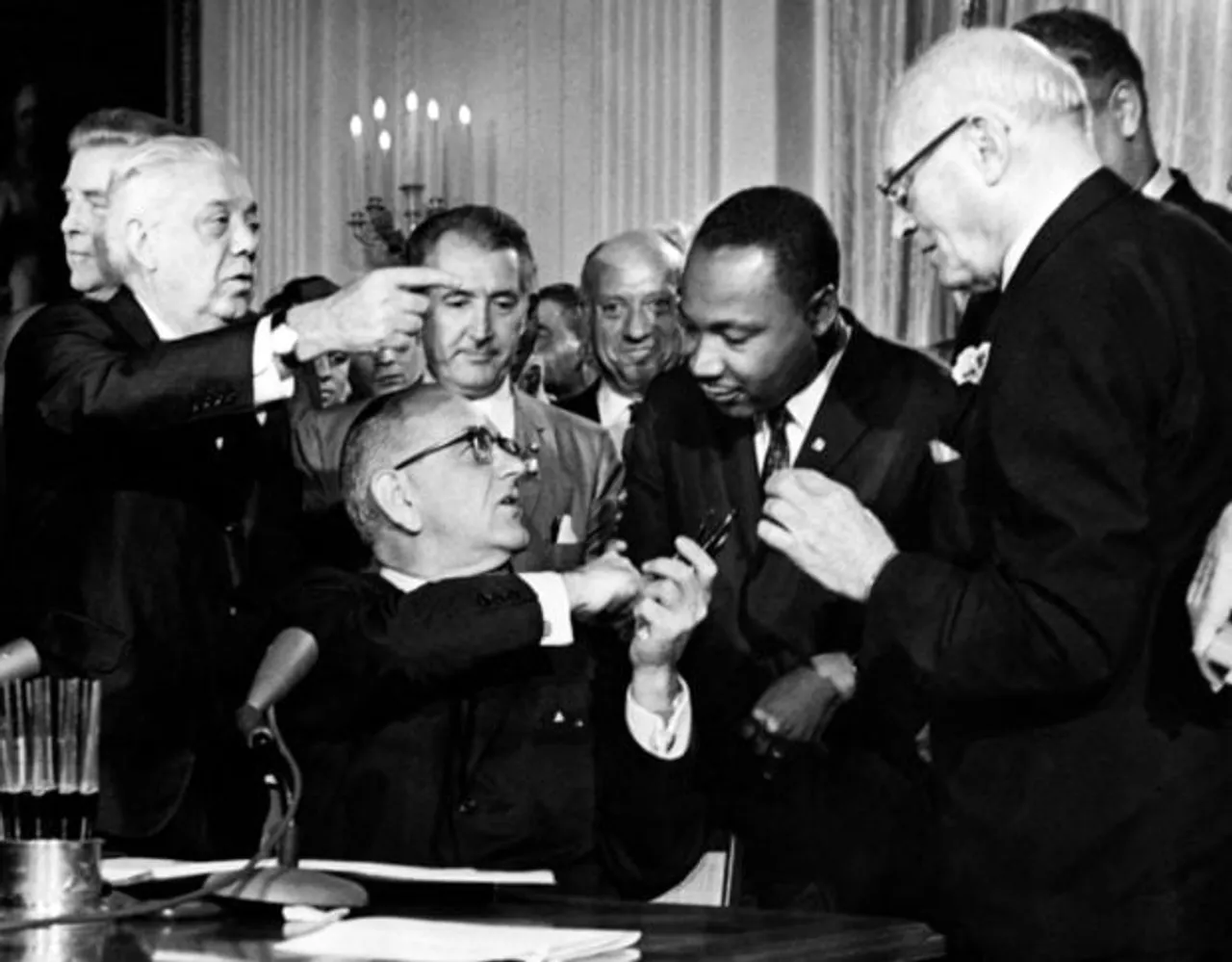 US President Lyndon B. Johnson hands a pent to the Rev. Martin Luther King (2nd-R) after signing the historic Civil Rights Act in the East Room of the White House, in Washington, D.C., 02 July 1964. The Civil Rights Act of 1964, signed into law by United States President Lyndon B. Johnson on July 2, 1964, put an end to all forms of segregation and discrimination based on race, color, religion, sex or national origin. (Photo by AFP) (Photo by -/AFP via Getty Images)