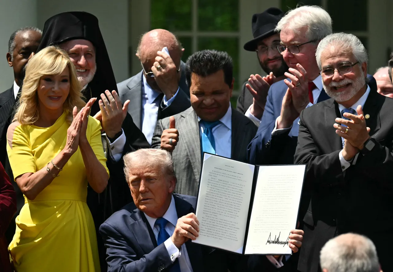 US President Donald Trump holds up an Executive Order on the "Establishment of the Religious Liberty Commission" while faith leaders react during a National Day of Prayer event in the Rose Garden of the White House in Washington, DC on May 1, 2025. (Photo by MANDEL NGAN/AFP via Getty Images)