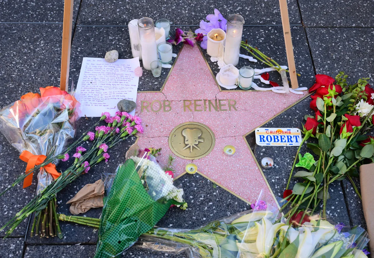 A growing makeshift memorial with flowers, candles and a letter are seen on the Hollywood Walk of Fames Star of the late US actor and director Rob Reiner on December 16, 2025, two days after he and his wife were found dead in the home in Brentwood, California. The son of famed Hollywood director Rob Reiner was not medically cleared for court on Tuesday, his lawyer said, as he awaits formal charging over the double murder of his parents. (Photo by Frederic J. BROWN / AFP via Getty Images)
