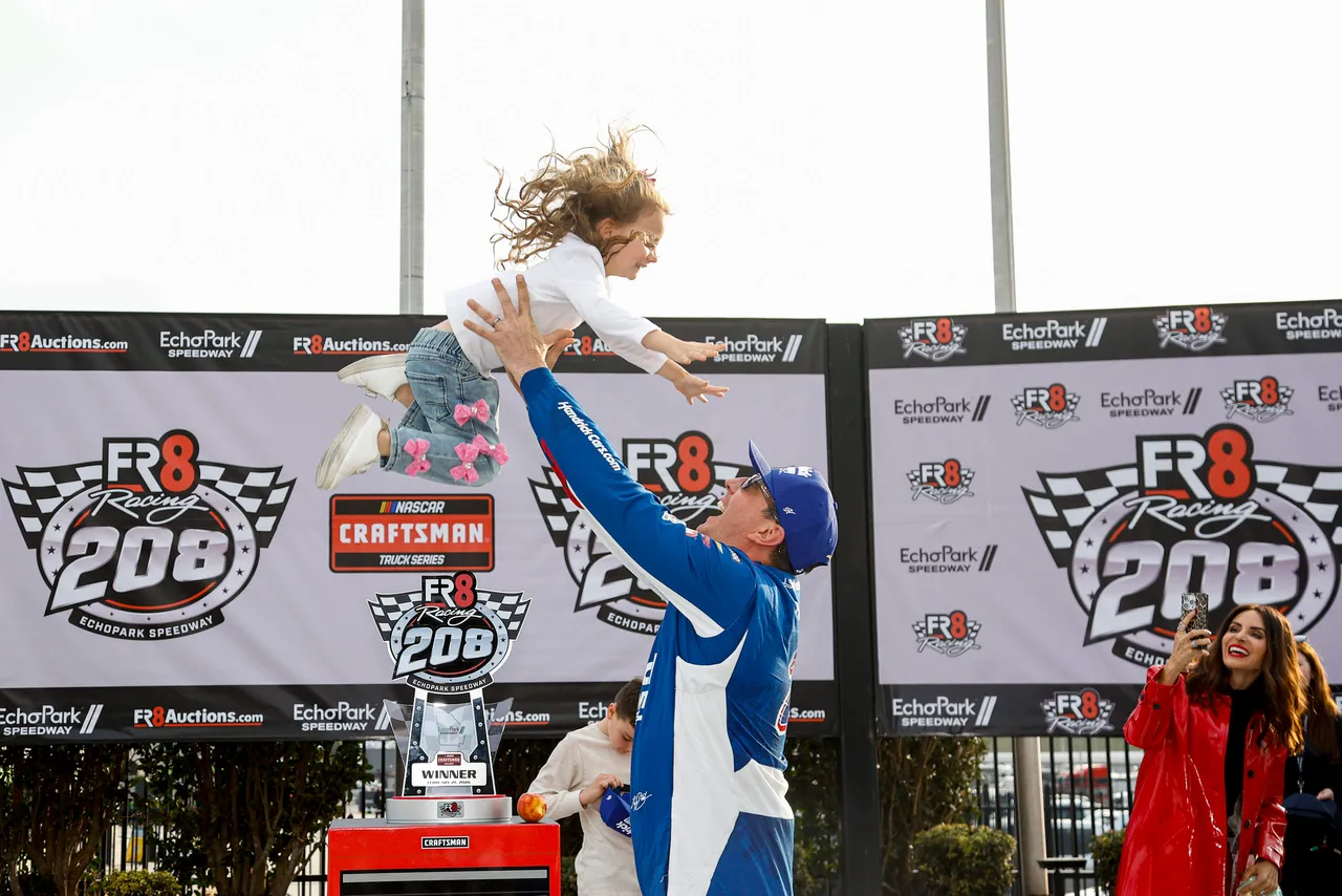 HAMPTON, GEORGIA - FEBRUARY 21: Kyle Busch, driver of the #7 HendrickCars.com Chevrolet, celebrates with his daughter, Lennix Busch in victory lane after winning the NASCAR Craftsman Truck Series Fr8 Racing 208 at Echo Park Speedway on February 21, 2026 in Hampton, Georgia. (Photo by Sean Gardner/Getty Images)