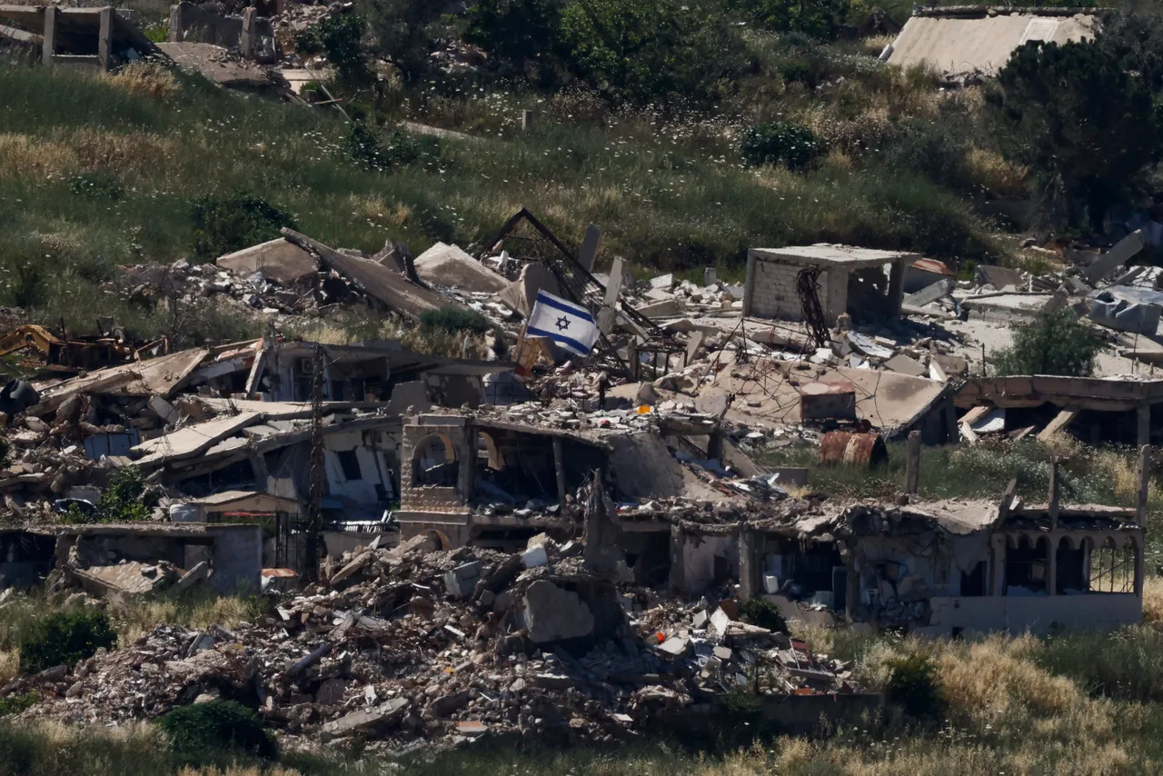 An Israeli flag held on top of a destroyed building in the southern Lebanese village of Kfar Kela near the border is pictured from the Upper Galilee in northern Israel, on June 4, 2026. (Photo by Jalaa MAREY / AFP via Getty Images)