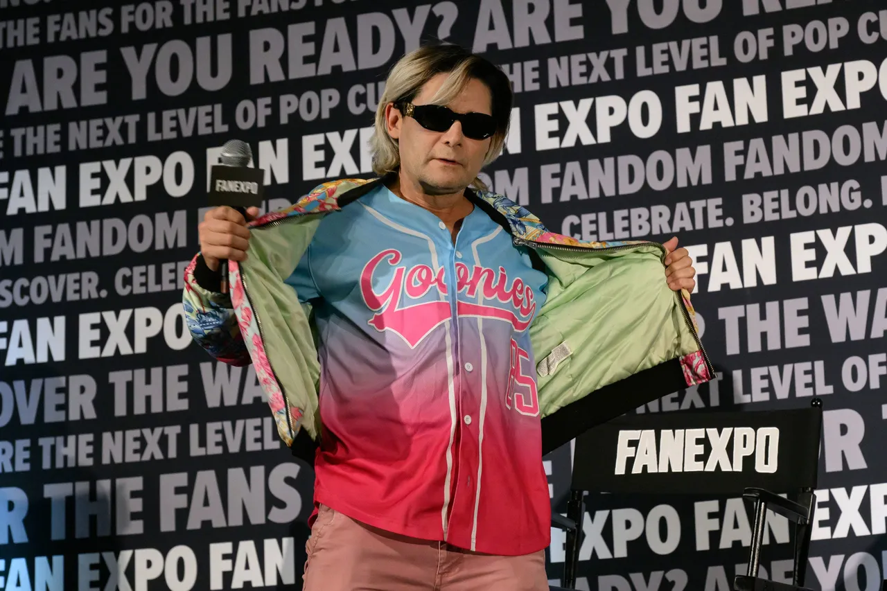 DENVER, COLORADO - MAY 31: Corey Feldman shows off his jersey at a "Never Say Die" reunion panel of "The Goonies" during the 2026 Fan Expo Denver at Colorado Convention Center on May 31, 2026 in Denver, Colorado. (Photo by Thomas Cooper/Getty Images)
