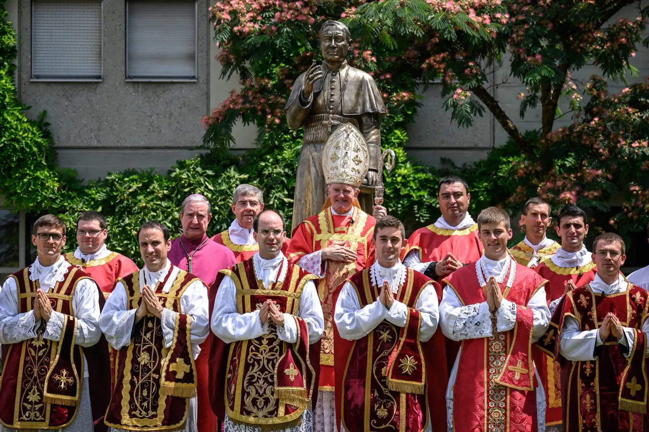 Swiss traditionalist Catholic Bishop and former Superior General of the Society of Saint Pius X (SSPX) Bernard Fellay, priests and deacons pose next to a statue of Saint Pius X after an ordination ceremony of the traditionalist Catholic Society of Saint Pius X (SSPX), in Econe, near Sion, western Switzerland, on June 29, 2026. (Photo by Fabrice COFFRINI / AFP via Getty Images)