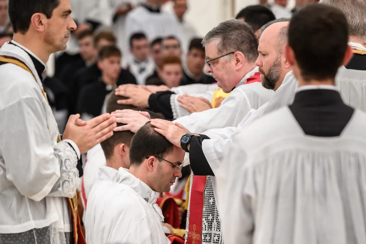 Spanish traditionalist Catholic priest of the Society of Saint Pius X (SSPX) Carlos Hernanz Gallego receives the laying on of hands by other priests during an ordination ceremony of the traditionalist Catholic Society of Saint Pius X (SSPX), in Econe, near Sion, western Switzerland, on June 29, 2026. (Photo by Fabrice COFFRINI / AFP via Getty Images)