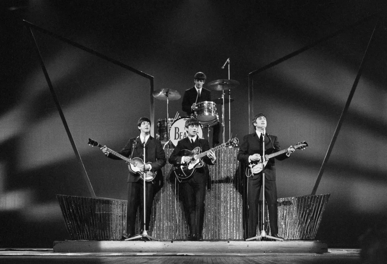 The Beatles on stage at the London Palladium during a performance in front of 2000 screaming fans. (Photo by Michael Webb/Keystone/Hulton Archive/Getty Images)