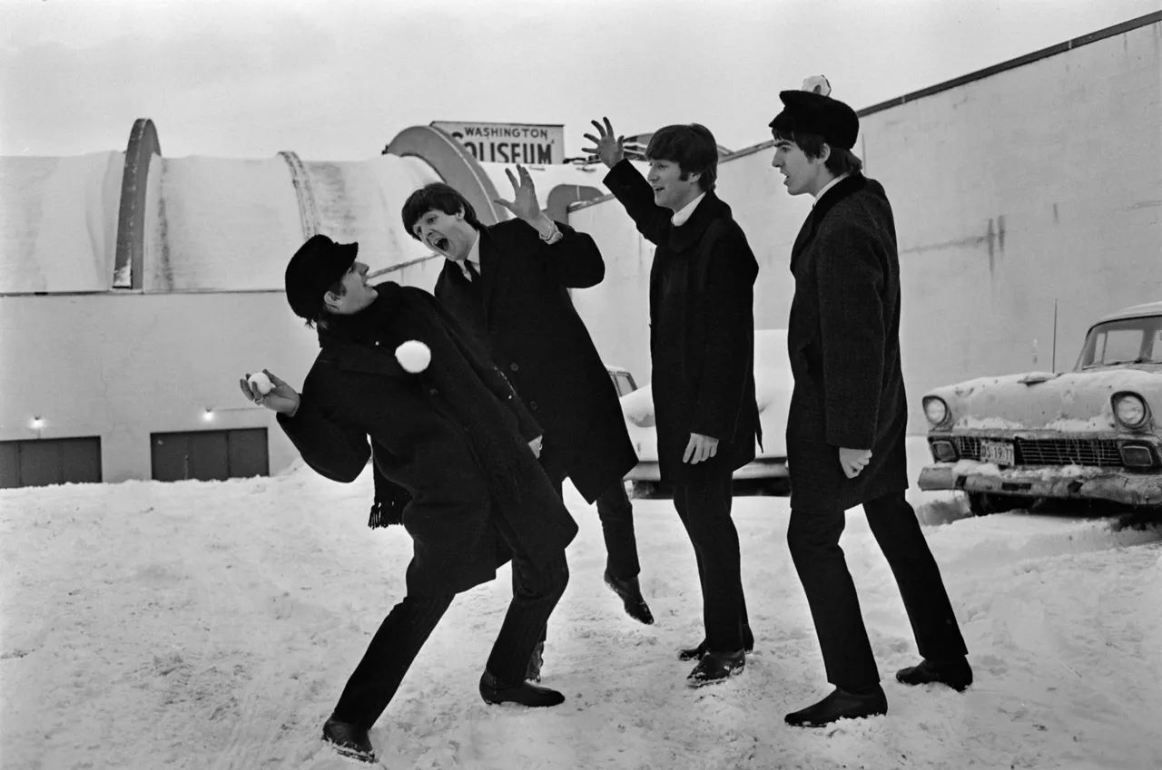 13th February 1964: The Beatles soon after their arrival in Washington, USA, playing in the snow outside the Coliseum where they were scheduled to perform before a sell-out audience. (Photo by Central Press/Hulton Archive/Getty Images)