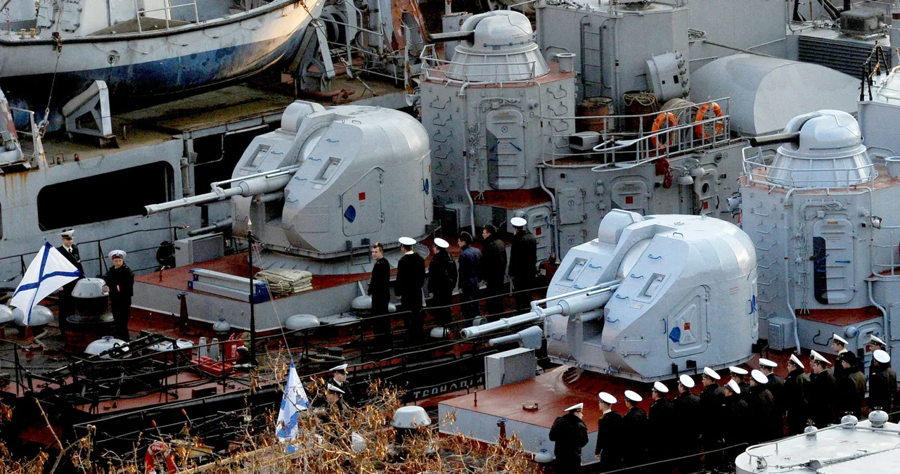 Former Ukrainian, now Russian navy sailors stand still during a Russian naval flag-raising ceremony at the deck of their ship, the 'Ternopil' ASW corvette (L), moored in the bay of the Crimean port of Sevastopol on April 1, 2014. (Photo by OLGA MALTSEVA/AFP via Getty Images)