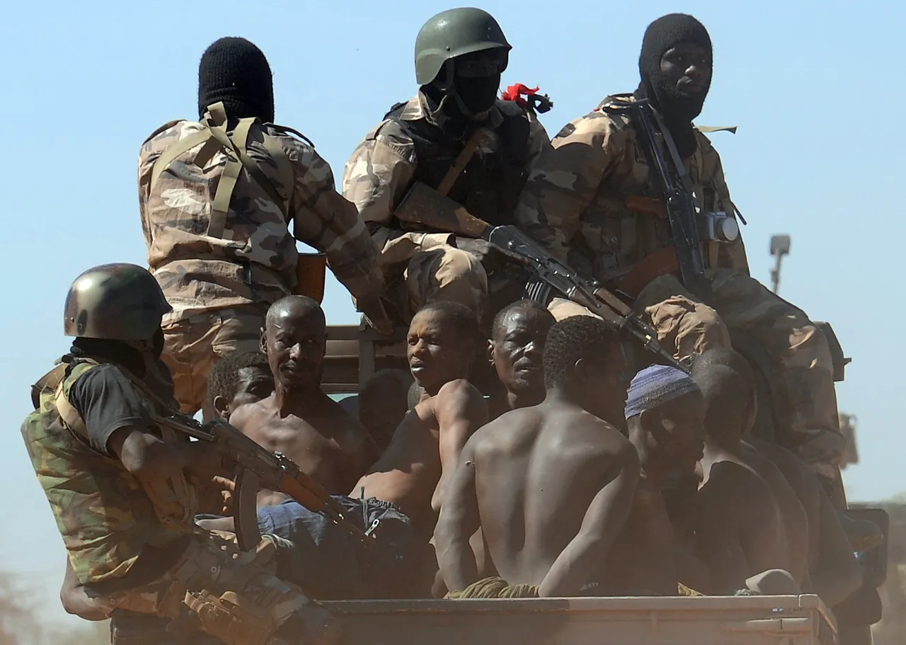 Malian soldiers transport in a pickup truck a dozen suspected Islamist rebels on February 8, 2013 after arresting them north of Gao. (Photo by PASCAL GUYOT/AFP via Getty Images)