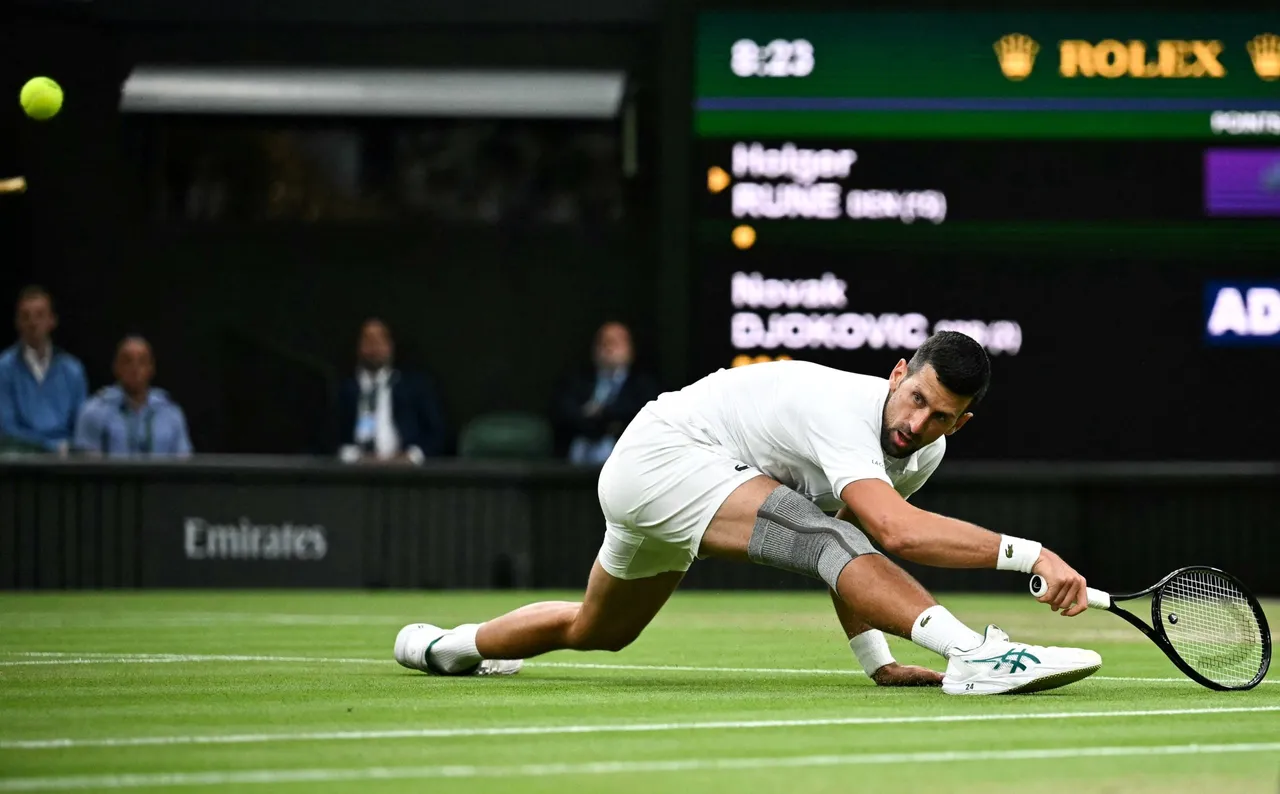 Serbia's Novak Djokovic eyes the ball as he slips to return it to Denmark's Holger Rune during their men's singles tennis match. (Photo by BEN STANSALL/AFP via Getty Images)