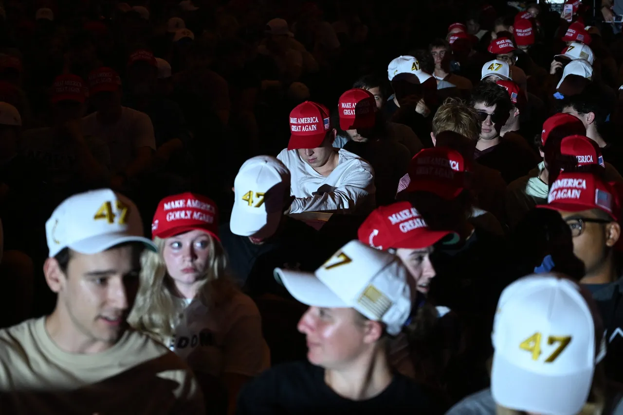 Attendees wear MAGA (Make America Great Again) hats during an "American Comeback Tour" stop hosted by Turning Point USA in Burruss Hall at Virgina Tech university in Blacksburg, Virginia, on September 24, 2025. (Photo by ALEX WROBLEWSKI/AFP via Getty Images)