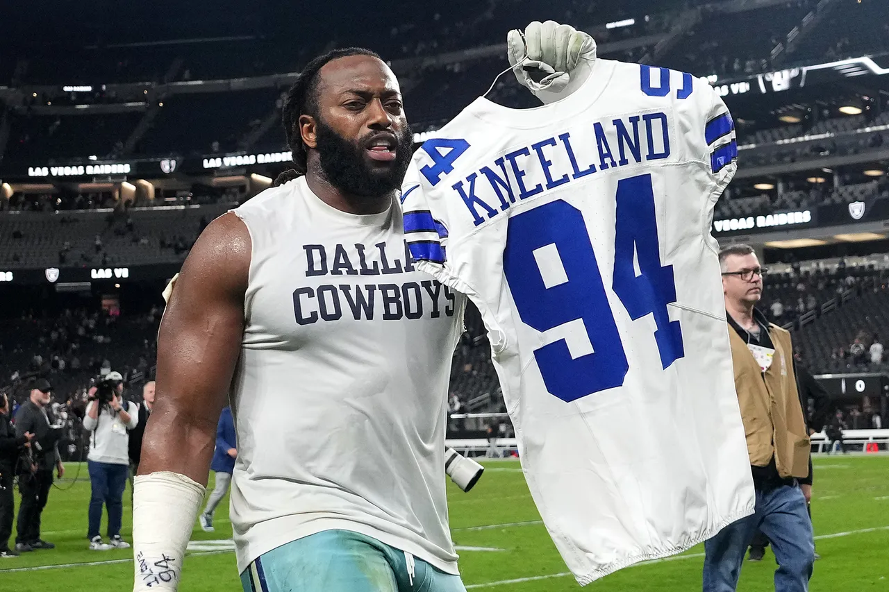 LAS VEGAS, NEVADA - NOVEMBER 17: Osa Odighizuwa #97 of the Dallas Cowboys holds the jersey of Marshawn Kneeland after the game against the Las Vegas Raiders at Allegiant Stadium on November 17, 2025 in Las Vegas, Nevada. (Photo by Candice Ward/Getty Images)