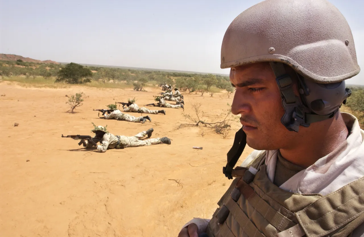 A U..S Marine supervises a battalion of Nigerien soldiers as they fire on a target during a training exercise September 22, 2004 in Samara, Niger. (Photo by Jacob Silberberg/Getty Images)