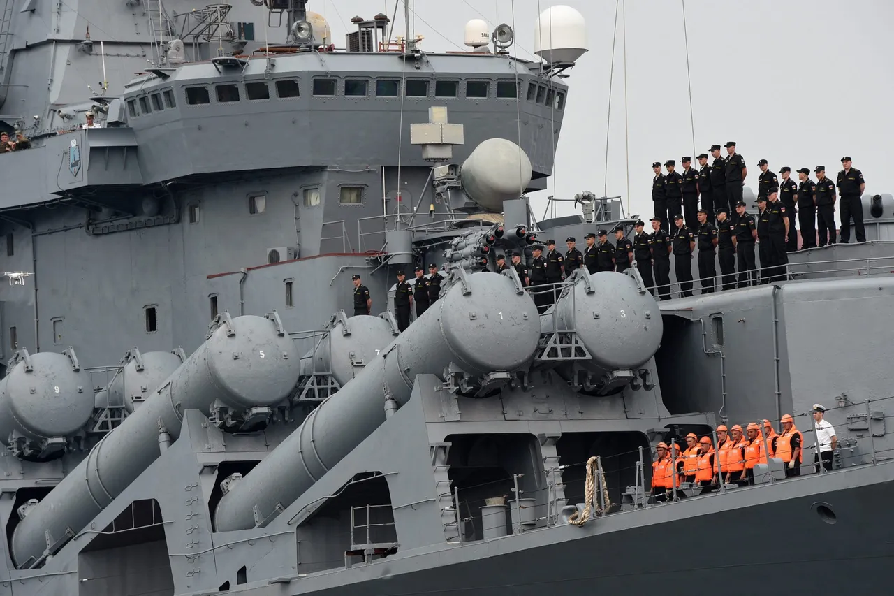 Russian sailors of the missile cruiser Varyag stand next to the missile launch pad as the vessel arrives at the international port of Manila on April 20, 2017. (Photo by TED ALJIBE/AFP via Getty Images)