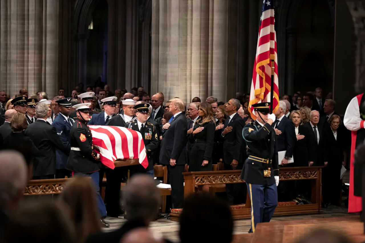 The flag-draped casket of former President George H.W. Bush is carried by a military honor guard past former President George W. Bush, President Donald Trump, first lady Melania Trump, former President Barack Obama, Michelle Obama, former President Bill Clinton, former Secretary of State Hillary Clinton, former President Jimmy Carter and Rosalynn Carter during a State Funeral at the National Cathedral, Wednesday, Dec. 5, 2018, in Washington. Alex Brandon/Pool via REUTERS