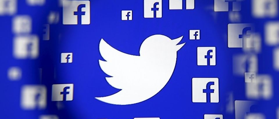 Logo of the Twitter and Facebook are seen through magnifier on display in this illustration taken in Sarajevo