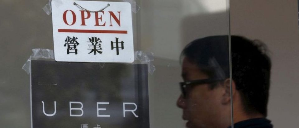 An open sign is seen at the office of taxi-hailing service Uber Inc during a driver recruitment event in Hong Kong