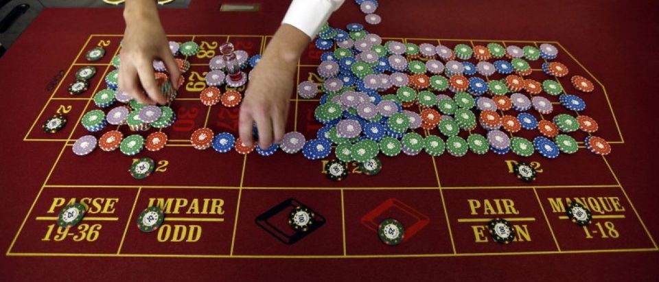 File photo of a young croupier trainee who practices near chips at a gaming table at the Cerus Casino Academy in Marseille