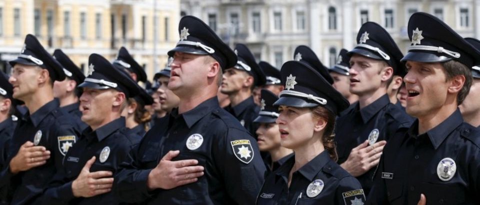 Police officers sing the national anthem as they attend an oath-taking ceremony, which started up the work of a new police patrol service, part of the Interior Ministry reform initiated by Ukrainian authorities, in Kiev, Ukraine, in this July 4, 2015 file photo. REUTERS/Valentyn Ogirenko/Files