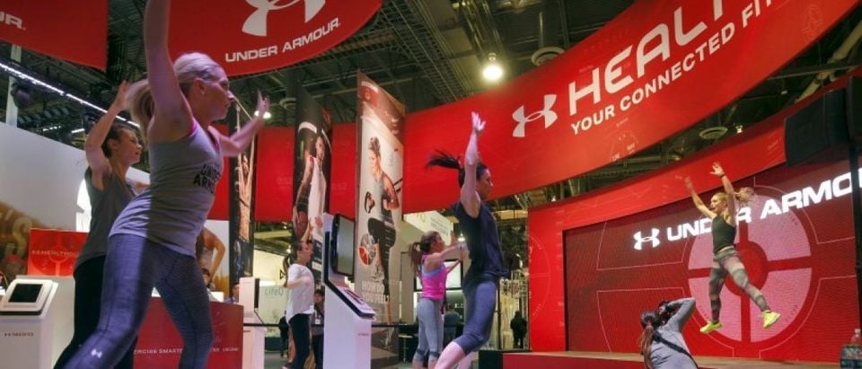 People work out at the Under Armour booth as the company promotes the Health Box, a Connected Fitness system, during the 2016 CES trade show in Las Vegas, Nevada