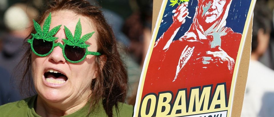 SAN FRANCISCO, CA - OCTOBER 25: A medical marijuana advocate who goes by the name The Holy Hemptress holds a sign as she demonstrates outside of the W Hotel where U.S. President Barack Obama was holding a fundraiser on October 25, 2011 in San Francisco, California. Hundreds of protestors from a wide variety of activist groups staged protests outside of the W Hotel where President Obama was holding a $7,500 per person fundraiser. (Photo by Justin Sullivan/Getty Images)