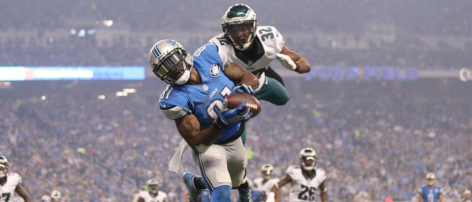 Wide receiver Calvin Johnson of the Detroit Lions catches a third quarter touchdown in front of cornerback Eric Rowe of the Philadelphia Eagles on Nov. 26, 2015 at Ford Field in Detroit