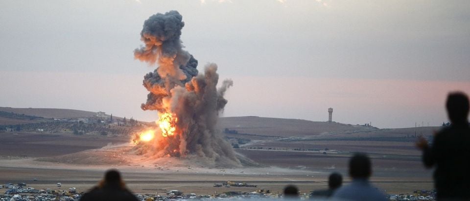 Smoke and flames rise over a hill near the Syrian town of Kobani after an airstrike