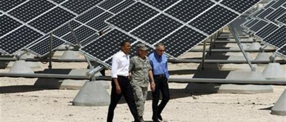 U.S. President Barack Obama (L) inspects an array of solar panels with U.S. Senate Majority Leader Harry Reid (R) and Colonel Howard Belote, base commander at Nellis Air Force Base in Las Vegas, Nevada May 27, 2009. (REUTERS/Jason Reed)