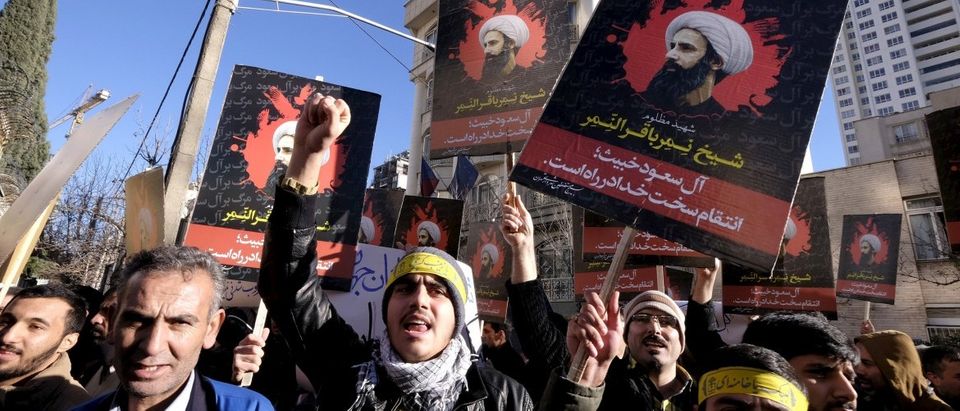 Iranian protesters chant slogans as they hold pictures of Shi'ite cleric Sheikh Nimr al-Nimr during a demonstration against the execution of Nimr in Saudi Arabia, outside the Saudi Arabian Embassy in Tehran