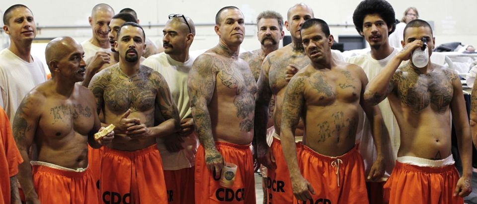 Inmates stand in a gymnasium where they are housed due to overcrowding at the California Institution for Men state prison in Chino, California, in this June 3, 2011 file photo. REUTERS/Lucy Nicholson/Files