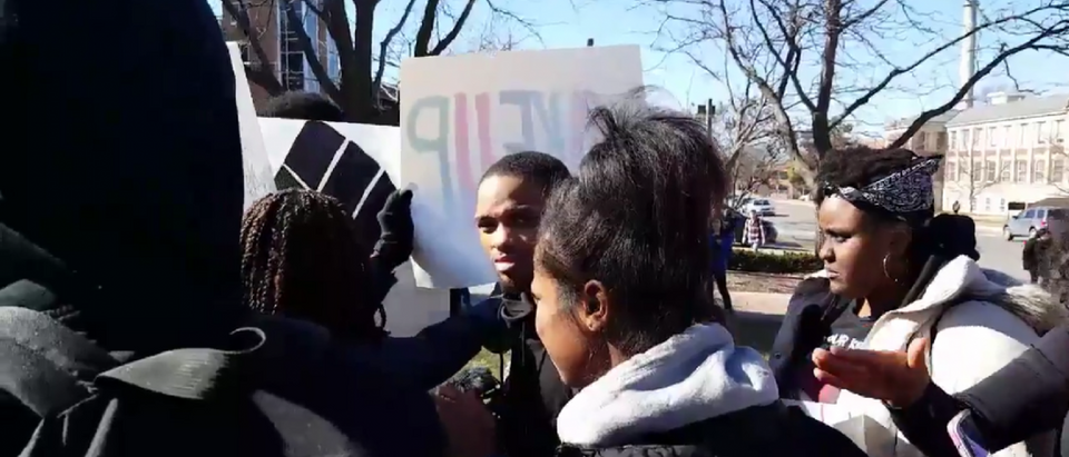 Concerned Student 1950 protesters work to block the view of a Columbia Missourian reporter [Twitter video screengrab]