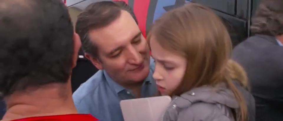 Ted Cruz, making an awkward effort to hug and kiss his unwilling daughter Caroline [YouTube screengrab]