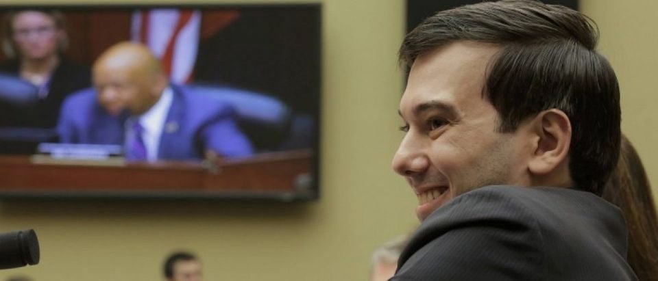 Martin Shkreli, former CEO of Turing Pharmaceuticals LLC, smiles as he listens to House Oversight and Government Reform Committee ranking member Rep. Elijah Cummings (seen on video screen) during a hearing on "Developments in the Prescription Drug Market Oversight" on Capitol Hill in Washington February 4, 2016. (REUTERS/Joshua Roberts)