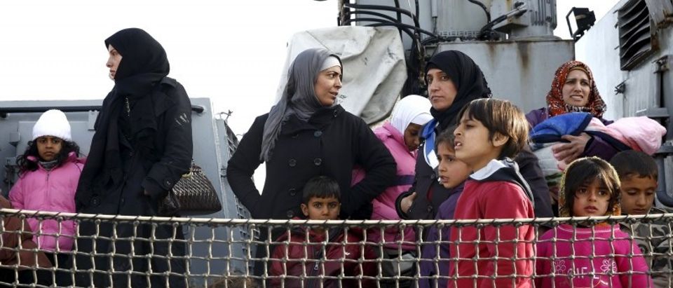 Refugees and migrants are seen aboard the Ayios Efstratios Coast Guard vessel following a rescue operation, at the port of the Greek island of Lesbos