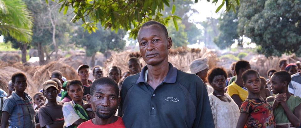 Jean-Pierre Kitenge Amisi, a Bantu, poses for a photograph with Budjita Kyungu Ndaye, a Pygmy, in Nyemba village, in southeastern Democratic Republic of the Congo