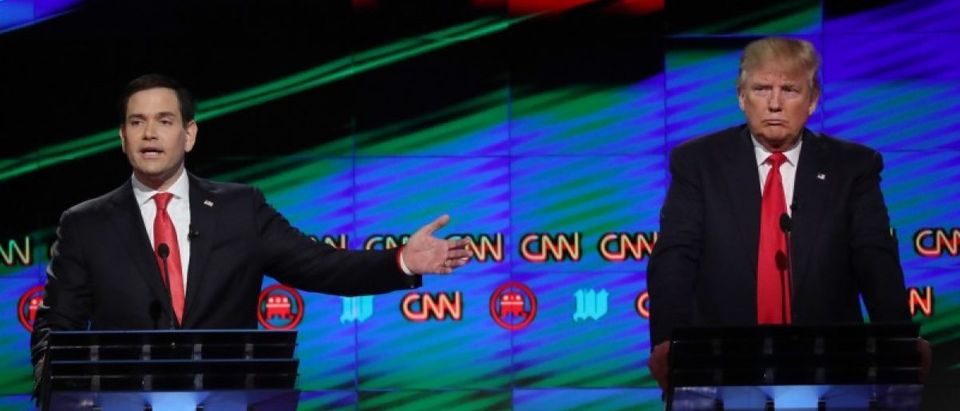 Republican U.S. presidential candidate Rubio speaks as rival Trump listens during a debate in Miami
