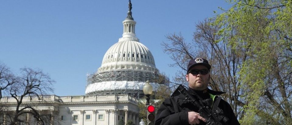 A U.S. Capitol police officer guards the perimeter in front of the U.S. Capitol Building after a shooting at the U.S. Capitol Visitors Center in Washington