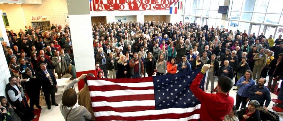 Voters recite the Pledge of Allegiance at a Republican U.S. presidential caucus in Salt Lake City, Utah March 22, 2016. REUTERS/Jim Urquhart