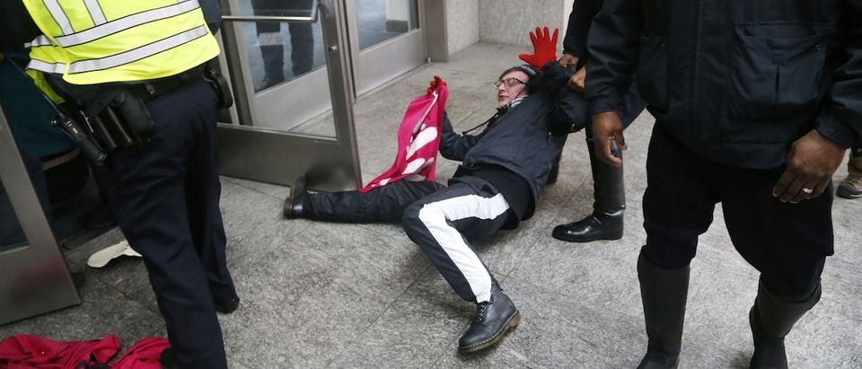 Police forcibly remove anti-Israel demonstrators led by the protest group Code Pink from the entrance to the American Israel Public Affairs Committee (AIPAC) policy conference at the Washington Convention Center in Washington
