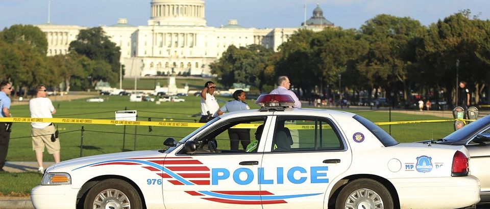 A Washington police car arrives at the scene where a man set himself on fire near the U.S. Capitol on the U.S. National Mall in Washington