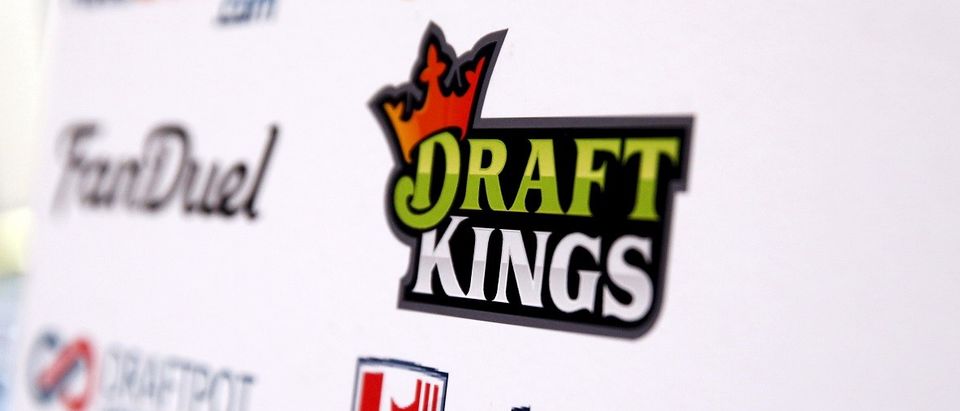 A DraftKings logo is displayed on a board inside of the DFS Players Conference in New York