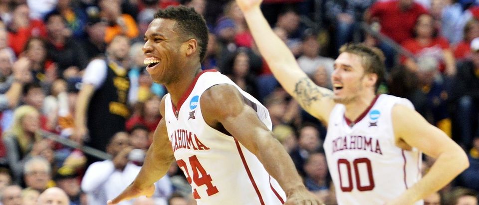 COLUMBUS, OH - MARCH 22: Buddy Hield #24 and Ryan Spangler #00 of the Oklahoma Sooners celebrate their 72 to 66 win over the Dayton Flyers during the third round of the 2015 NCAA Men's Basketball Tournament at Nationwide Arena on March 22, 2015 in Columbus, Ohio. (Photo by Jamie Sabau/Getty Images)