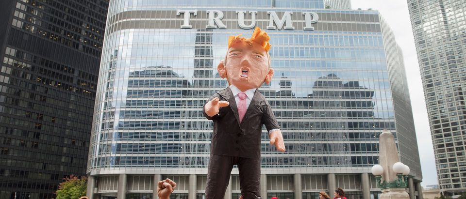 CHICAGO, IL - OCTOBER 12: Demonstrators hold up a piñata of Republican Presidential candidate Donald Trump during a protest outside Trump Tower on October 12, 2015 in Chicago, Illinois. About 250 demonstrators marched through downtown before holding a rally calling for immigration reform and fair wages in front of Trump Tower. Trump has been an outspoken proponent of a plan to deport undocumented immigrants. (Photo by Scott Olson/Getty Images)