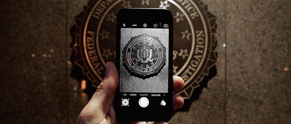 The official seal of the Federal Bureau of Investigation is seen on an iPhone's camera screen outside the J. Edgar Hoover headquarters February 23, 2016 in Washington, DC. Last week a federal judge ordered Apple to write software that would allow law enforcement agencies investigating the December 2, 2015 terrorist attack in San Bernardino, California, to hack into one of the attacker's iPhone. Apple is fighting the order, saying it would create a way for hackers, foreign governments, and other nefarious groups to invade its customers' privacy. Chip Somodevilla/Getty Images.