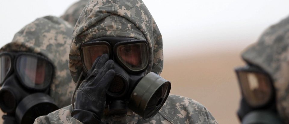 Soldiers wear masks as they take part in a military exercise simulating a chemical weapons attack during the international Eager Lion military event on June 2, 2014 at Prince Hashem Bin Abdullah II training center, in Zarqa, 30 km east of Amman, Jordan. The US and the Kingdom of Jordan are conducting Exercise Eager Lion, which has been conducted annually since 2011, and includes countries from five different continents and more than 12,500 participants. Khalil Mazraawi/AFP/Getty Images.