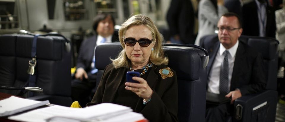 Hillary Clinton using her personal BlackBerry during trip to Libya. (REUTERS/Kevin Lamarque)