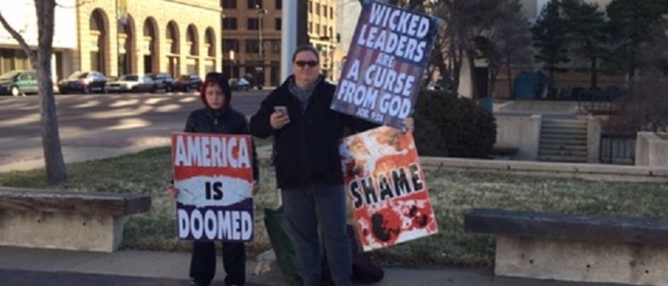 Westboro Baptist Church member Lee Ann Phelps protests outside of GOP Caucus site in Wichita, Kan. March 5, 2016.