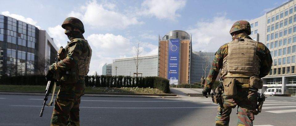 Belgian soldiers patrol outside the European Commission headquarters after explosions in Brussels